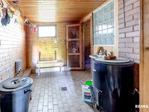 Pesuhuone, jossa lattialämmitys, lämminvesivaraaja sekä pata lämmintä vettä varten