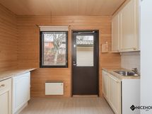 Kodinhoitohuoneesta on käynti suojaisalle takapihalle.