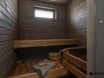 Tunnelmallinen tummasävyinen sauna.