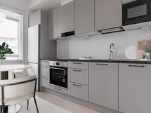 Digistailattu asunto A 23 - Tyylikäs harmaan sävyinen Puustellin keittiö, jossa tummat työtasot ja integroidut kodinkoneet tuovat modernia ilmettä.