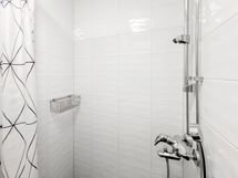 Suihku on omassa syvennyksessä, joka on suihkuverholla suljettavissa.