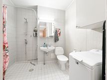 Iso kylpyhuone jossa on pesukoneliitäntä