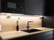 Keittiössä on musta allas ja hana