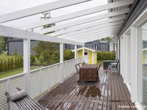 Terassipergola on lähes koko talon levyinen.