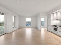 Valokuva asunnon A 42 olohuoneesta ja keittotilasta.