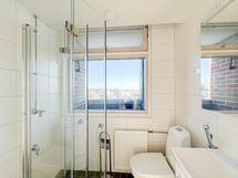 Harvinaisen iso ikkuna myös kylpyhuoneessa tuo valoa ja näköaloja aamutoimiin.