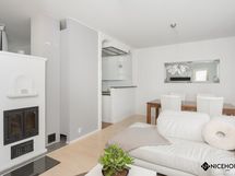 Avara olohuone ja ruokailutila, jossa on varaava takka.