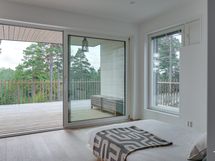 Alakerran makuuhuoneessa lasiliukuovet terassille