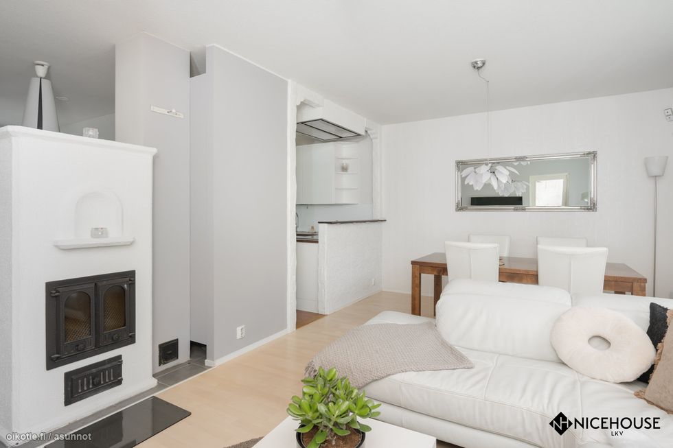 Avara olohuone ja ruokailutila, jossa on varaava takka.