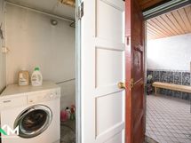 Pyykinpesukone ja ovi kylpyhuoneeseen